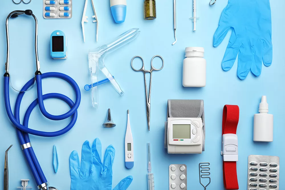 A collage of many medical equipment items from scissors to stethoscopes and eye drops